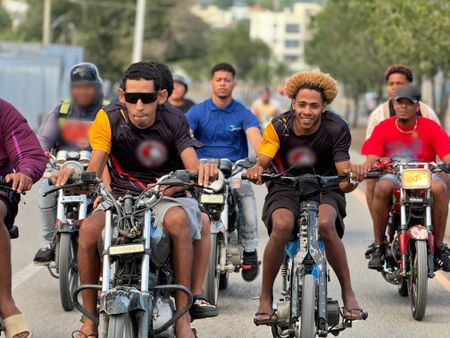 A group rides their bikes down a street in Santiago. (Credit: National Geographic)
