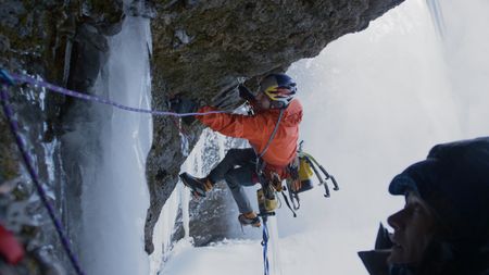 Will Gadd installs hardware along the route up Helmcken Falls, as Sarah Hueniken watches from below.  (mandatory credit: Red Bull Media House)