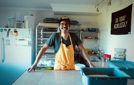Justin Gomez poses for a portrait in his basement bakery in Martinez, Calif. A cottage baker, Justin produces naturally leavened breads through his home business, Humble Bakehouse, which he named like that because nothing can humble a baker quite like sourdough. (National Geographic/Ryan Rothmaier)