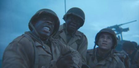 Soldiers help Corporal William Dabney (played by Joshua Riley) raise the barrage balloon in a scene of a WW2 historic reenactment production for "Erased: WW2's Heroes of Color." Corporal Dabney served with the 320th Barrage Balloon Battalion on D-Day. (National Geographic)