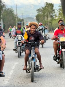 A group rides their bikes down a street in Santiago. (Credit: National Geographic)