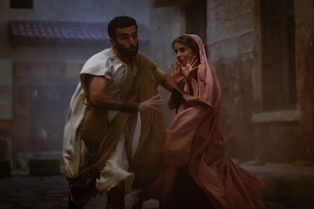 A panicked man runs towards Claudia, played by Madeleine Walker, nearly knocking her over as Mt. Vesuvius begins to erupt. (National Geographic/Darrin Zammit Lupi)