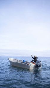 Marvin Agnot on his boat in the ocean, setting crab pots. (National Geographic/Ashton Hurlburt)
