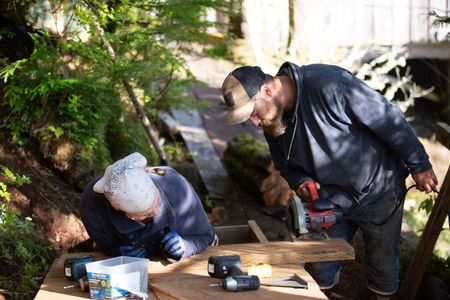 Veronica Arrants is helped by Carl Hernandez with a ramp construction on her property. (National Geographic/Mickey Ramos)