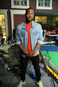 Keon Poole smirking while standing in front of camera equipment. (National Geographic/Robert Toth)