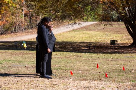 Braylon Brown and Marilyn Brown, nephew and sister of David Brown, reflect at David's  unmarked grave. (National Geographic/Tom Beard)