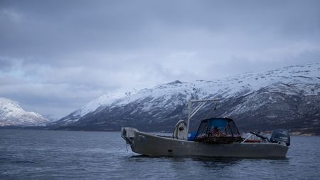 Marvin Agnot sets crab pots in the water. (National Geographic/Ashton Hurlburt)