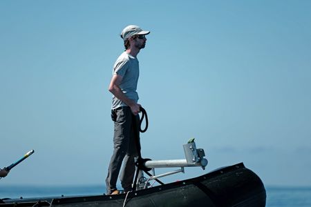 Rui Prieto stands at the bow of the Zodiac. (National Geographic/Mario Tadinac)