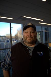 Dr. Tobey Curtis standing in the lobby of the School for Marine Science and Technology in New Bedford, MA just before showing the rest of the team the analysis of the data from Liberty's tag. (National Geographic/Zara Tyne)