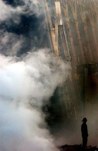 9/11: ONE DAY IN AMERICA - A solitary fire fighter stands amidst the rubble and smoke in New York City on September 14, 2001. Days after a Sep. 11 terrorist attack, fires still burn at the site of the World Trade Center. (Photo Credit: U.S. Navy/Mate 2nd Class Jim Watson)