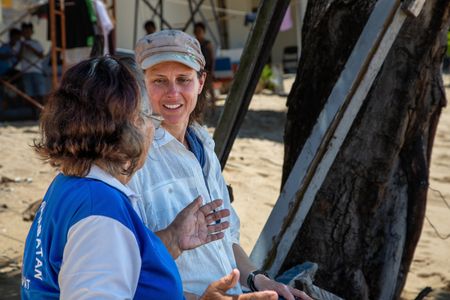 Bunaken resident, Tante Ita, left, and Dr. Crissy Huffard discussing Algae octopus (Abdopus aculeatus) on the shores of Bunaken Island.  (photo credit: National Geographic/Annabel Robinson)