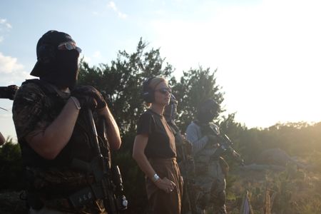 Mariana van Zeller stands with members of the Black Cat Rifle Group. (National Geographic)