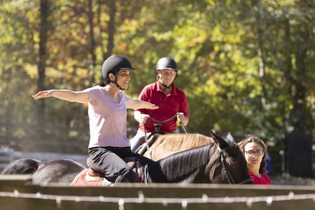 Debbie St. John and Stefan Horlacher ride horses together during their reunion. (National Geographic/Virginia Sherwood)