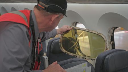 Martin Trojahn, Maintenance Team Leader, inspects a cracked window from the 787. (Arrow International Media Ltd & Cantina Media)