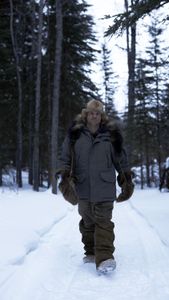 Jamey Joseph setting marten traps in the woods. (National Geographic/Ashton Hurlburt)