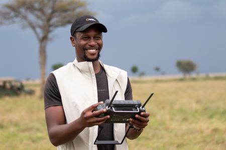 Drone pilot Anthony Njuguna operates his drone. (National Geographic/Joe Treddenick)