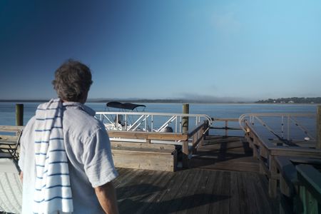 Gene Brooks on his dock at the Wilmington River, heading out for a swim. (National Geographic/Martin Cass)
