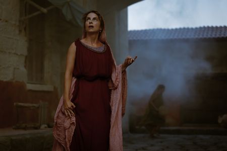 Claudia, played by Madeleine Walker, looks up at the eruption column of Vesuvius, her eyes wide in horror and fear. (National Geographic/Darrin Zammit Lupi)