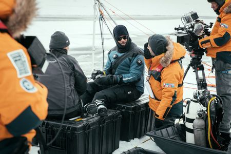 Will Smith prepares to dive under the ice with Dr. Allison Fong to collect samples in the waters of the North Pole. (credit: National Geographic/Freddie Claire)