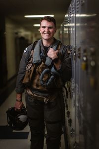 Student LTJG Dylan Horan poses by lockers on Meridian Naval Base. (National Geographic/Freddie Claire)