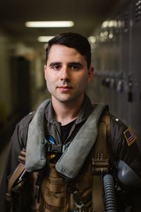 Student LTJG Marcus Figueroa posing in the hallway on base. (Credit: National Geographic/Freddie Claire)