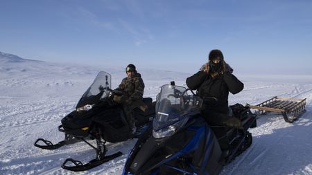 Chris Apassingok and his sister, Nalu Apassingok hunt for caribou during the winter season. (National Geographic/Zach Clanton)