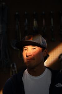 Filmmaker and climber Jimmy Chin with some climbing gear behind him in Los Angeles, CA.  (photo credit: National Geographic/Teague Wasserman)