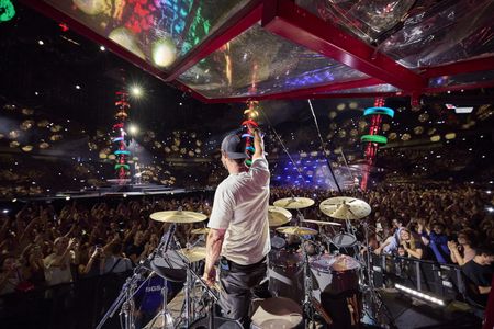 Chris Hemsworth drums during the Ed Sheeran concert in Bucharest. (credit: National Geographic/Evan Paterakis)