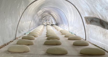 Loaves of bread rise at Istanbul Halk Ekmek, or IHE, a municipal program that produces high-quality, low-cost bread for the people of Istanbul. (National Geographic/Peter Richardson)