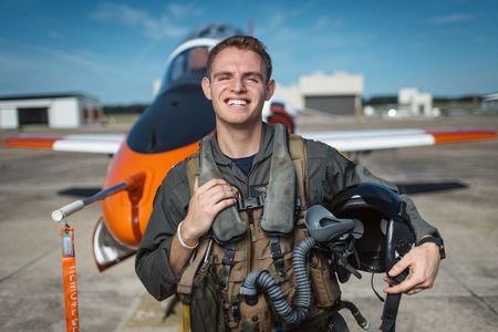 Student LTJG Evan Morris posing in front of a T-45. (National Geographic/Freddie Claire)