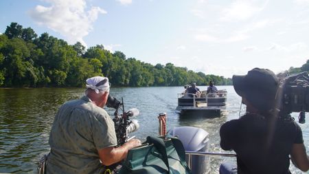 Christian Cooper and Cristopher Joe take in the vibrant birdlife on the Alabama River. (National Geographic for Disney)