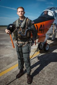 Student LTJG Evan Morris posing in front of a T-45. (National Geographic/Freddie Claire)