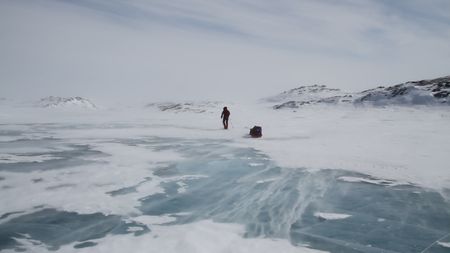 Sarah-McNair Landry walking through a snowy lanscape, as she crossed the Northwest Passage.   (photo credit: National Geographic /Sarah McNair-Landry)
