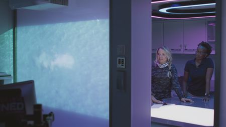 Erin Spencer and Zoleka Filander review the footage of a great hammerhead predating a stingray. (National Geographic)