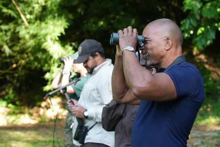 Christian Cooper observes the historic release of 7 Puerto Rican Parrots into the wild with Marisel López-Flores Lopez, the Project Leader of the Puerto Rican Parrot Recovery Program. (National Geographic for Disney)