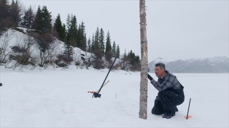 Joel Jacko builds a dock during the winter season. (National Geographic)