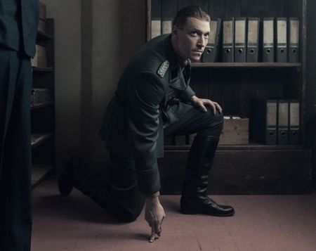 A SMALL LIGHT - Silberbauer, played by Daniel Donskoy, discovers marks on the floor in the Opekta office as seen in A SMALL LIGHT. (Credit: National Geographic for Disney/Dusan Martincek)