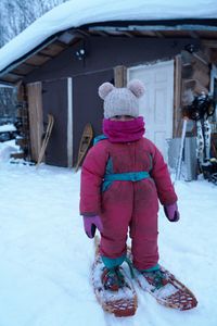 Chevelle Roach wears snowshoes before heading out with her mother to set rabbit snares. (BBC Studios Reality Productions, LLC/Jayce Kolinski)