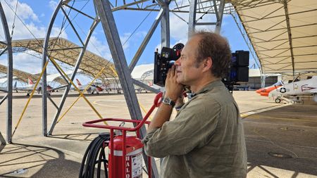 DOP Jon Southgate-Sayers filming ground crew as a jet spools up. (Credit: National Geographic/Lyndsi Gutierrez)